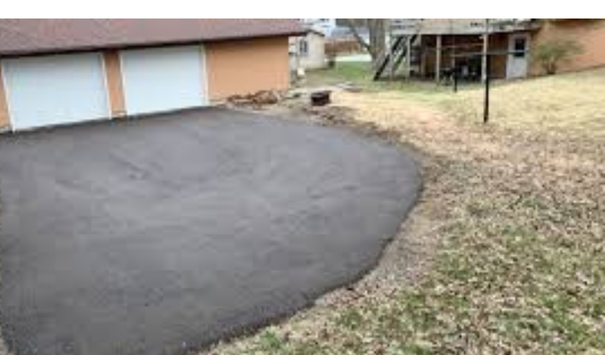 Excavation and compacted sub-base ready for a new tarmac driveway
