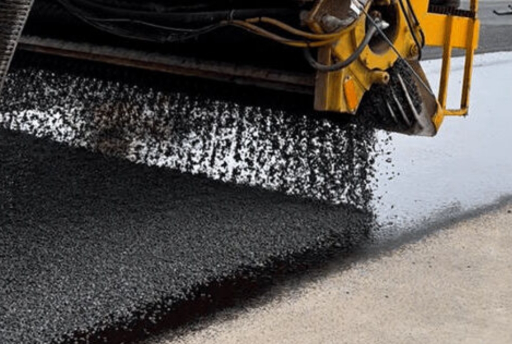 Spreading tar and chip on a driveway 